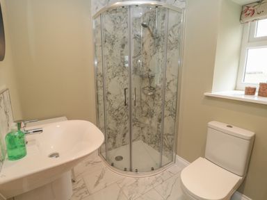 A bathroom with a shower enclosure a sink and a toilet at Todridge Barn in Corbridge