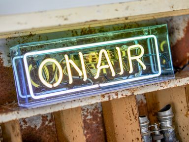 A neon sign reading on air placed on a rusty metal surface at 1 Pringles Yard in Alnwick