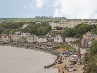 A coastal town with a beach promenade and buildings on a hillside at Arbour Retreat in Filey