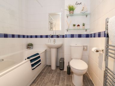 A bathroom with a bathtub a sink and a toilet at Valentines Cottage in Stratford-Upon-Avon