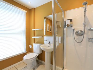 A bathroom with a toilet sink and shower at Armorel House in Dartmouth