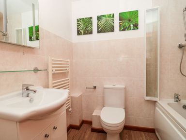 A bathroom with a sink cabinet toilet bathtub and shower at The Willow Lodge near Lyme Regis