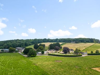 A rural landscape with farm buildings fields and trees at The Anchorage @ Nables Farm in Upper Seagry