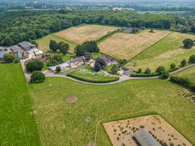 An aerial view of farms fields trees buildings and roads at The Anchorage @ Nables Farm in Upper Seagry
