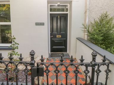 A black front door with the number 5 and a mail slot at Hawthorn House in Pembroke