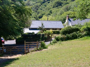 A rural property with houses surrounded by trees and greenery at Higher Bumsley Barn Parracombe