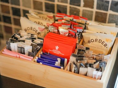 A wooden tray with assorted packets of tea coffee and Border biscuits at Pine Tree in Otterburn