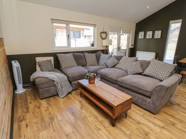 A living room with a sofa and coffee table at Barn Owl in Otterburn