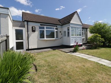A bungalow with a front porch and garden pathway at Garden View in Quintrell Downs near Newquay