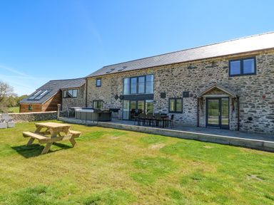 An outdoor area with a picnic bench dining table and lounge chairs at Bwthyn Y Bugail Shepherd's Cottage in Pedairffordd near Llanrhaeadr-Ym-Mochnant