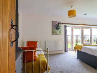 A bedroom with beds and a painting at Bwthyn Y Bugail (Shepherd's Cottage) Pedairffordd near Llanrhaeadr-Ym-Mochnant