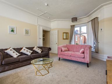A living room with two sofas and a glass coffee table at Sunnymeade in Buxton Norfolk