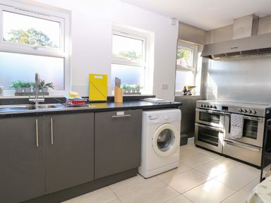 A kitchen with a sink and washing machine at Sunnymeade in Buxton Norfolk
