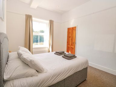 A bedroom with a bed and towels on top at Sunnymeade in Buxton, Norfolk