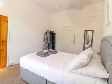 A bedroom with a bed and towels on top at Sunnymeade in Buxton, Norfolk