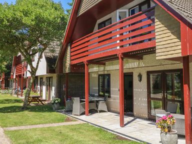 Exterior view of houses with balconies patios and garden furniture at 32 Trevithick in Hayle
