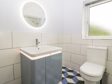 A bathroom with a sink cabinet mirror and toilet at Strawberry Stables in Iwood near Congresbury