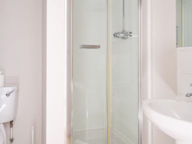 A bathroom with a shower enclosure a toilet and a sink at Grubbings in Graythwaite near Hawkshead