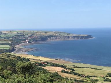 A coastal landscape with cliffs fields and sea at Jonstone Pines in Cayton Bay near Scarborough