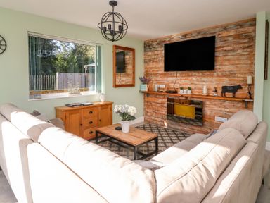A living room with a sofa and coffee table at Bluebell Wood in Brandesburton