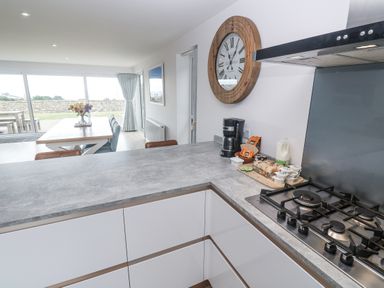 A kitchen with a counter gas stove and coffee maker at Atlantic View in Germoe