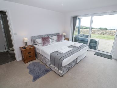 A bedroom with a bed and nightstand at Atlantic View in Germoe