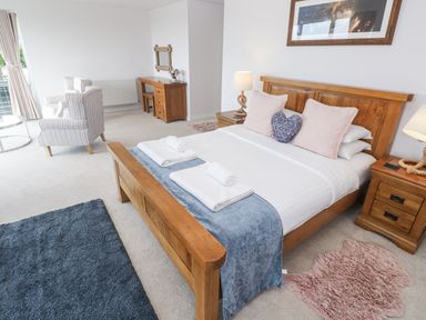 A bedroom with a bed and furniture at Atlantic View in Germoe