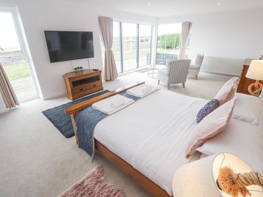 A bedroom with a bed and seating area at Atlantic View in Germoe