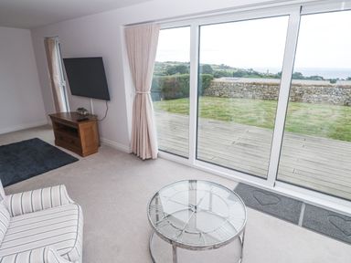 A living room with a television and coffee table at Atlantic View in Germoe