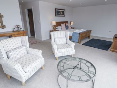 A living room with chairs and a coffee table at Atlantic View in Germoe