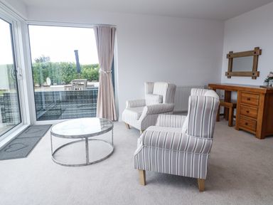 A living room with chairs and a coffee table at Atlantic View in Germoe