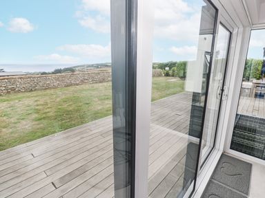 A view of a garden area with a stone wall at Atlantic View in Germoe