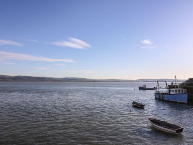 A body of water with small boats and hills in the background at The Look Out in Aberdovey