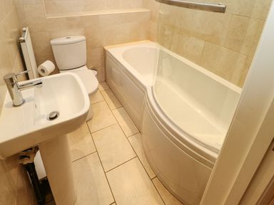 A bathroom with a sink a toilet and a bathtub with a glass shower screen at Houghton North Farm Cottage in Heddon-on-the-Wall near Hexham
