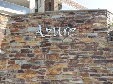A stone wall with the word Azure on it outside a building at Newquay Fistral Beach View in Newquay