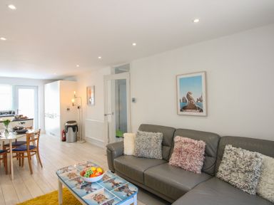 A living room with a sofa and dining table at Little Starboard in Kingsbridge