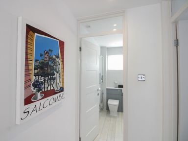 A bathroom with a toilet and sink at Little Starboard in Kingsbridge