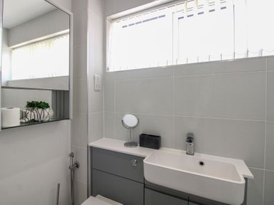 A bathroom with a sink and mirror at Little Starboard in Kingsbridge