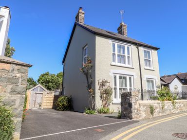 A two storey detached house with a driveway and stone wall at Morawel in Newport Pembrokeshire