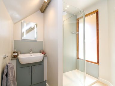 A bathroom with a sink cabinet and mirror and a walk in shower at Cherrywood Barn in South Petherton
