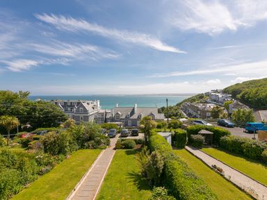 A garden with pathways and hedges overlooking houses and the sea at 6 Albany Terrace in St Ives