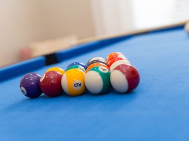 A set of billiard balls arranged on a blue pool table at 6 Albany Terrace in St Ives