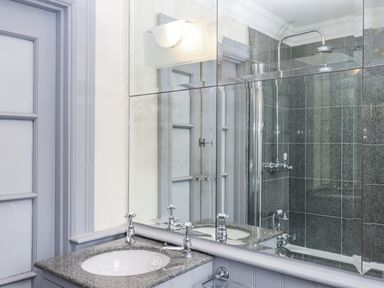 A bathroom with a sink and shower at Lion House in Moretonhampstead