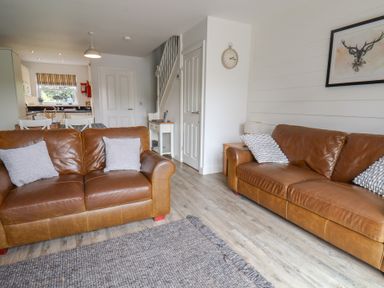 A living room with two sofas and a table at Buck Place The Bay - Filey