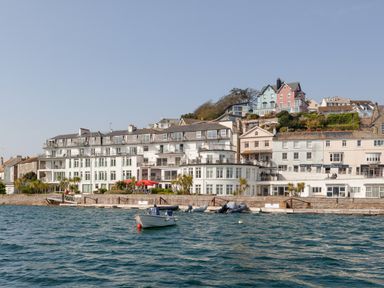 Seaside buildings with boats floating in the water at 32 The Salcombe in Salcombe