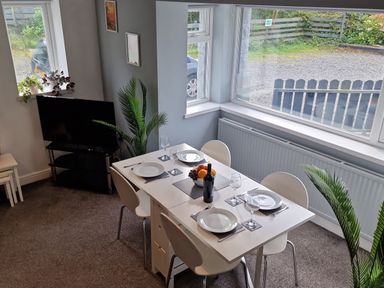 A dining room with a table and chairs at Bryn in Bethesda