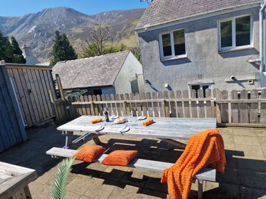 A picnic table with tableware and an orange blanket at Bryn in Bethesda