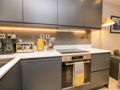A kitchen with a built in oven stovetop microwave kettle toaster and knife set at River View in Backbarrow