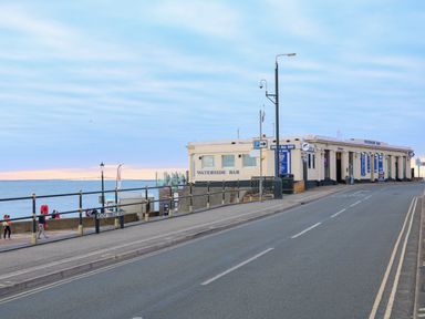 A road with railings along the seaside and a building labeled waterside bar at Northgate Ground Floor Flat in Hunstanton