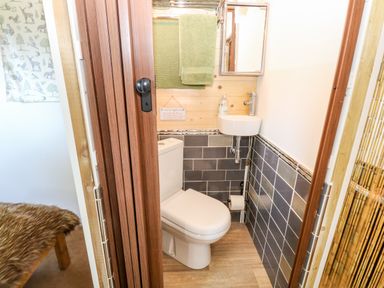 A small bathroom with a toilet sink and towel in Hugatree Little Dunham near Litcham